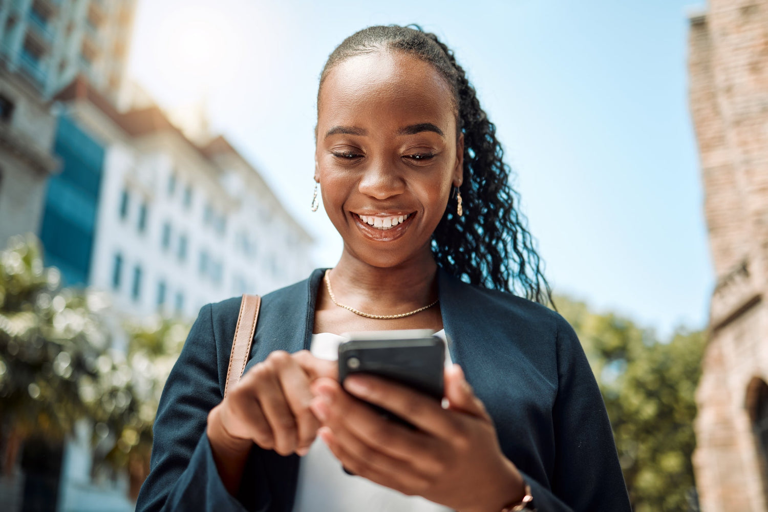 woman smiling looking at phone